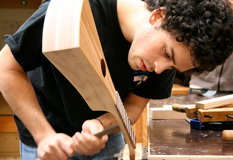 Photo of student using wood working tools.