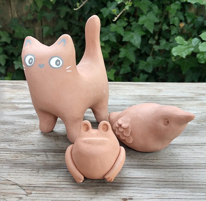 ceramic cat, frog, and bird