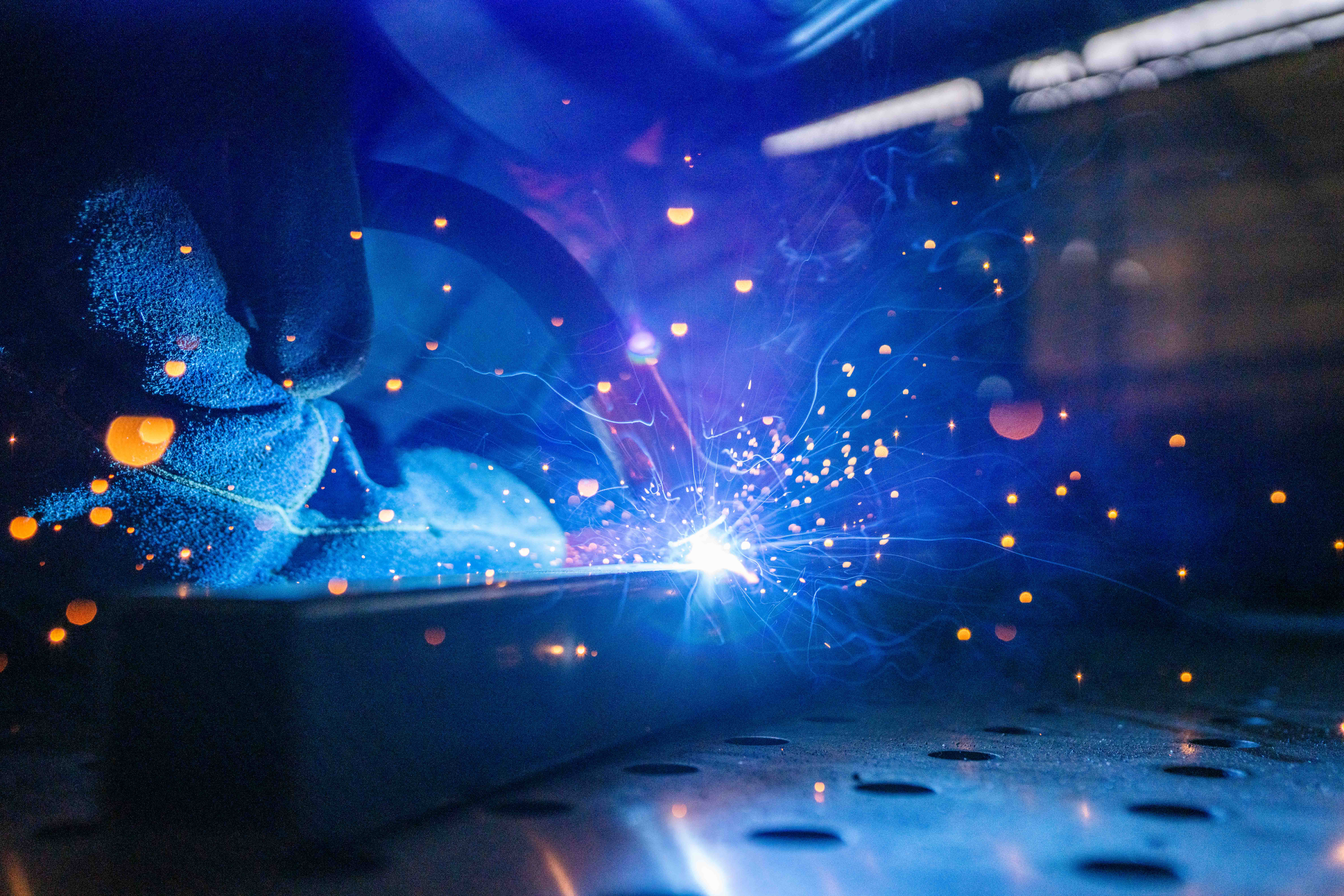 Student welding metal bars together.