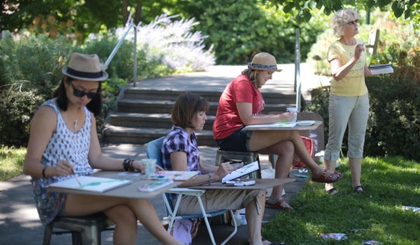 Participants enjoy an outdoor watercolor workshop.