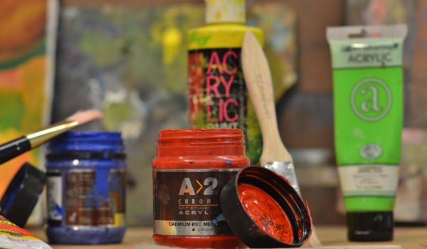 Acrylic paint of different colors and paint brushes.