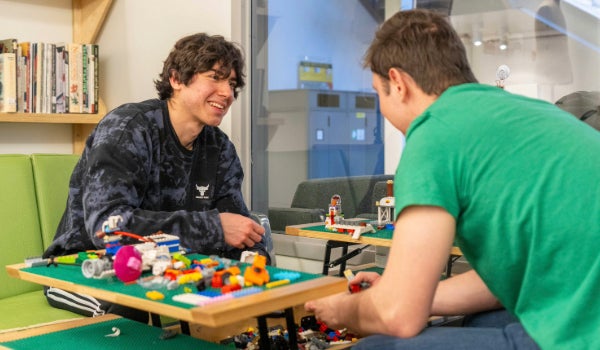 Two students build Lego together at the Craft Center.