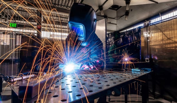 A welder uses the Craft Center's ironworking studio and sparks go flying.